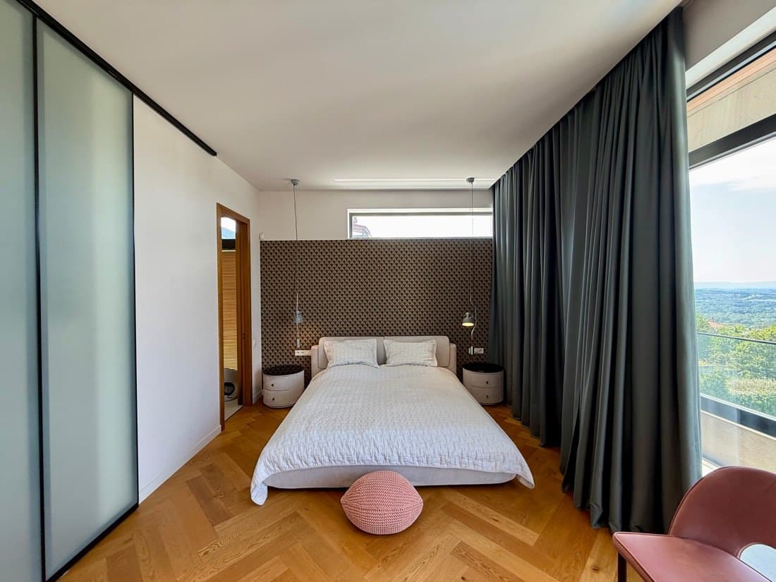 A second bedroom, glazed to the trees.