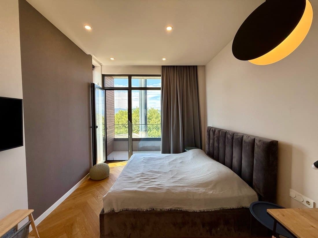 A bedroom, looking out to the trees.