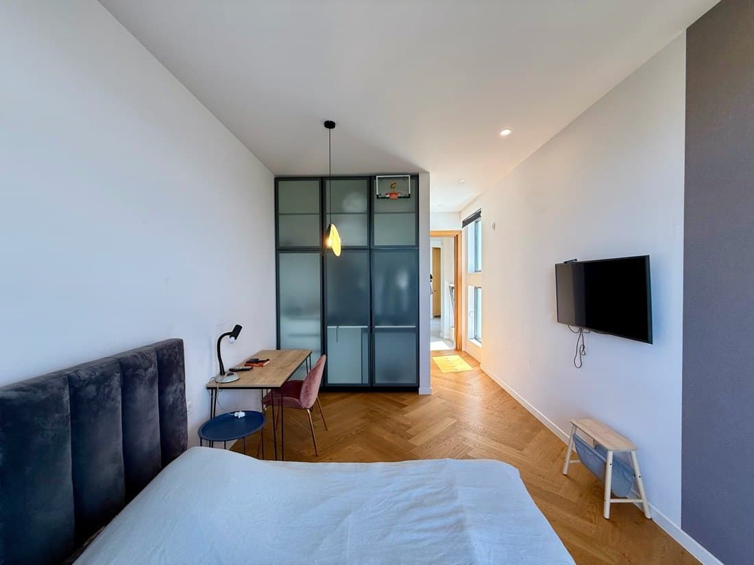 A bedroom with a study corner.