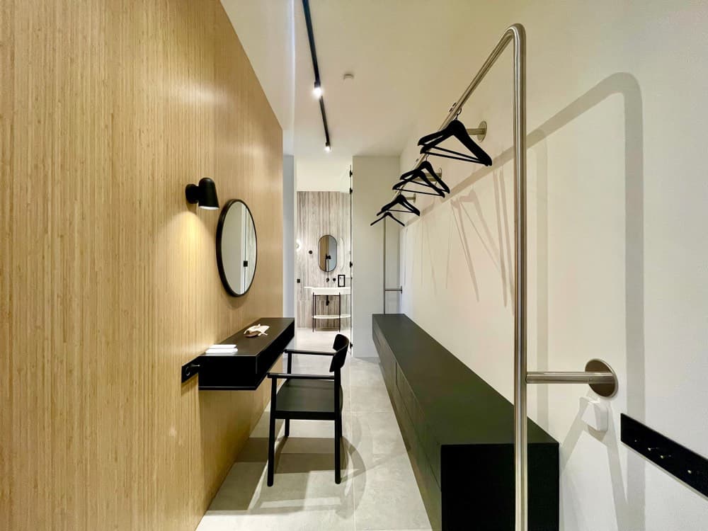 Walk-in closet, opening to the bathroom.