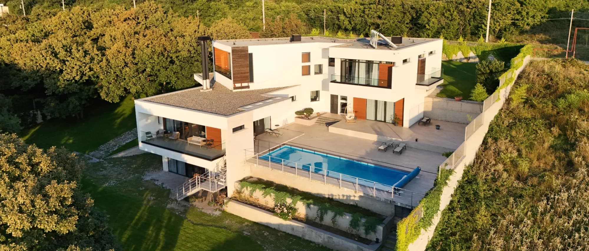 The villa from the air, with its terraces and pool, among the trees
