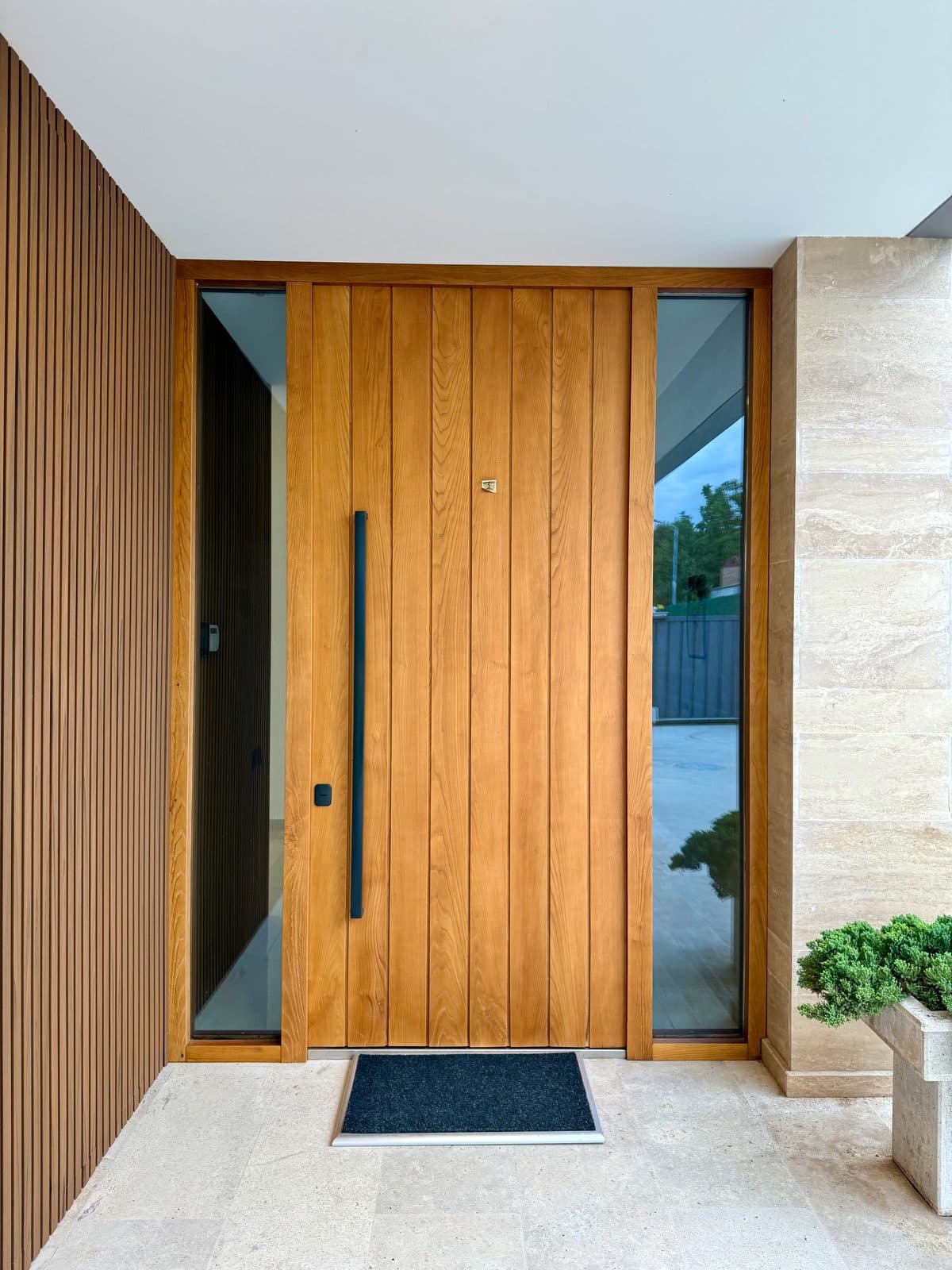 The entrance, in timber and stone.