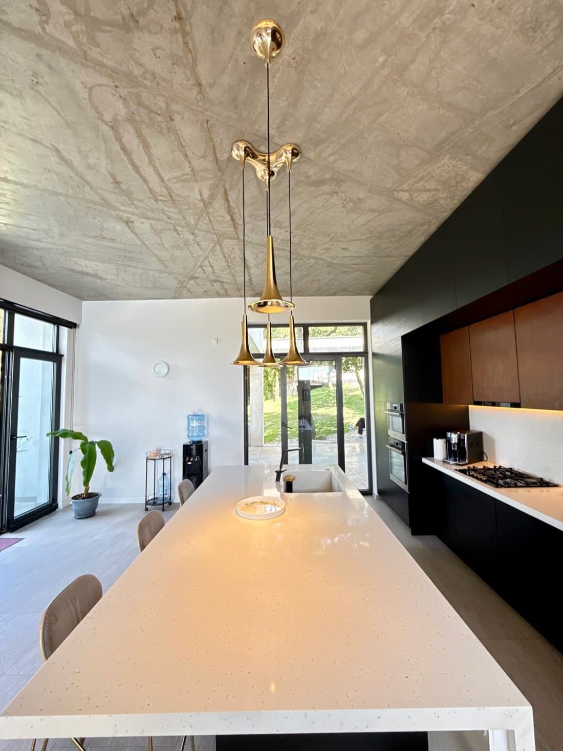 The kitchen island and its pendants.