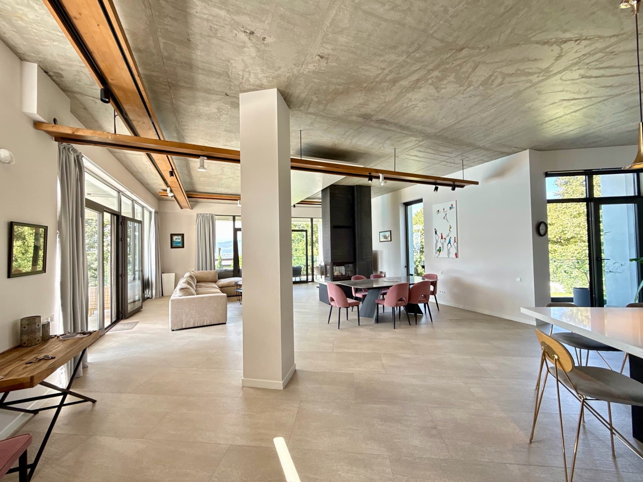The main floor: living, dining and kitchen under floor-to-ceiling glass.