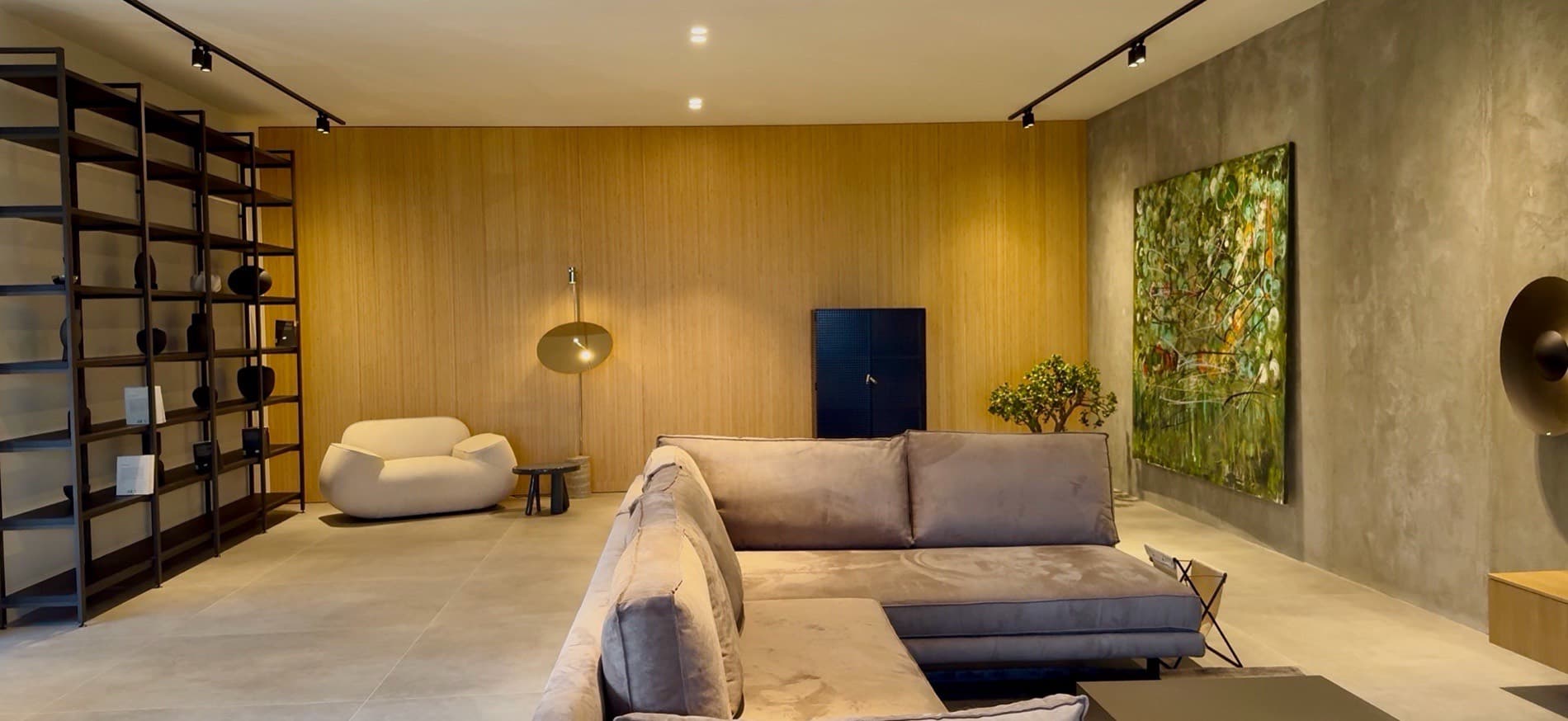The living room, with steel shelving to full height.