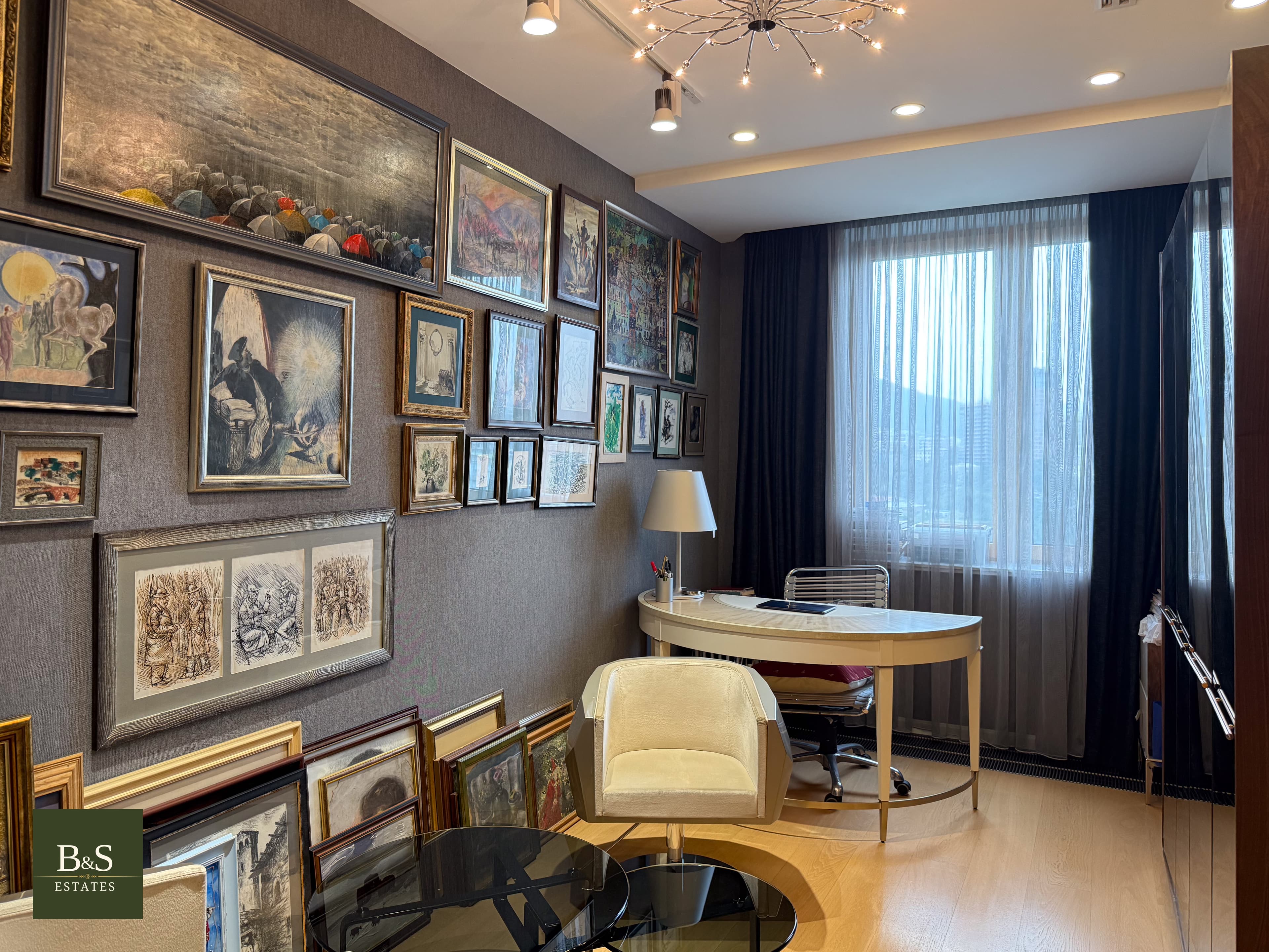 A study, hung with paintings.